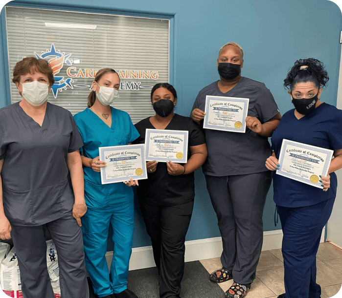 Five medical staffs wearing facemask while the four of them are holding certificates