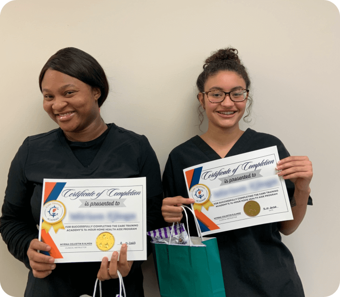 Two female medical staffs smiling while holding a certificates and a bag