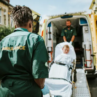 An medical staffs carrying a patient into an ambulance