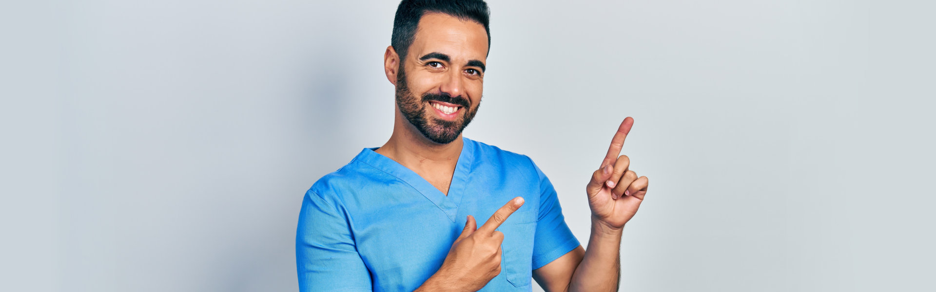 A male nurse doing pointy-finger pose