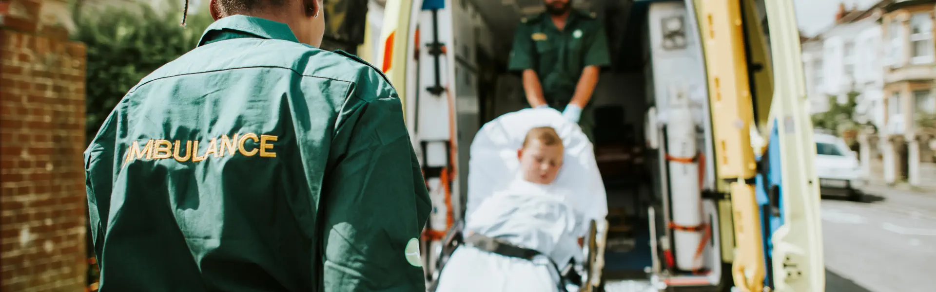 An medical staffs carrying a patient into an ambulance